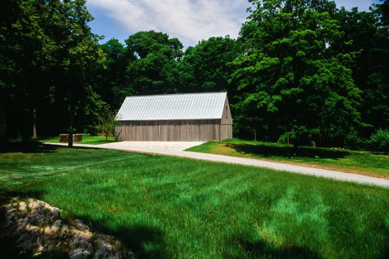 Post & Beam Barn Designed into the Landscape • Standing Seam Metal Roof