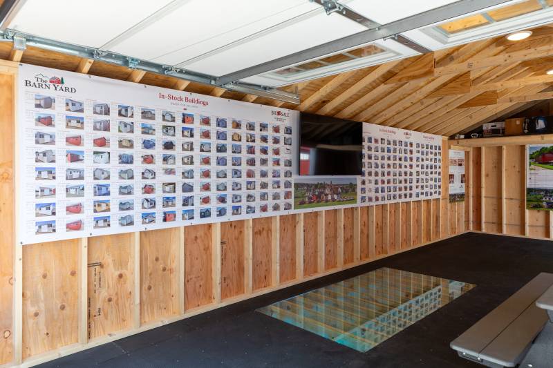 Inside the 14' x 30' Classic Cape Garage with Poly Armor Floor System, Super Floor cutout display, and Stock Board